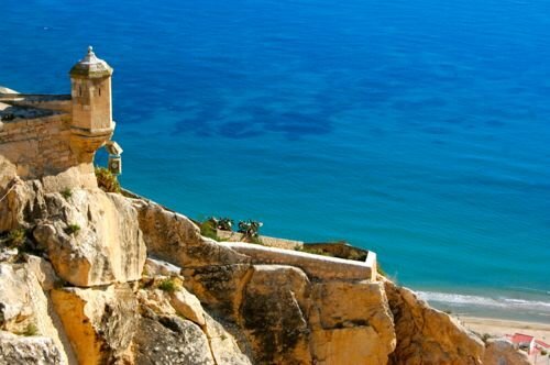 Alicante, Spain - Santa Barbara Castle, turret and blue sea - Alicante Airport car hire